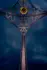 Color photo. A tall pillar rises up from the bottom of the frame and rises to meet a lattice at the top. A ring of golden light is present near the top as well.